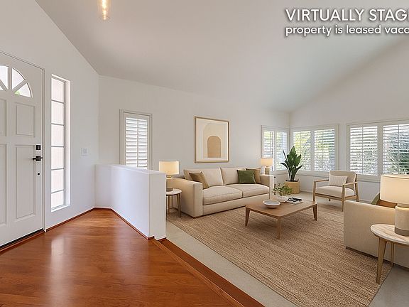Virtually staged to showcase the size and layout of this formal living room. Property is leased vacant.