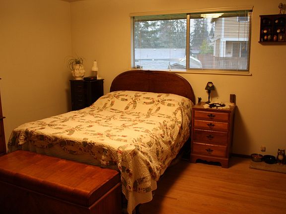 master bedroom with real wood floors