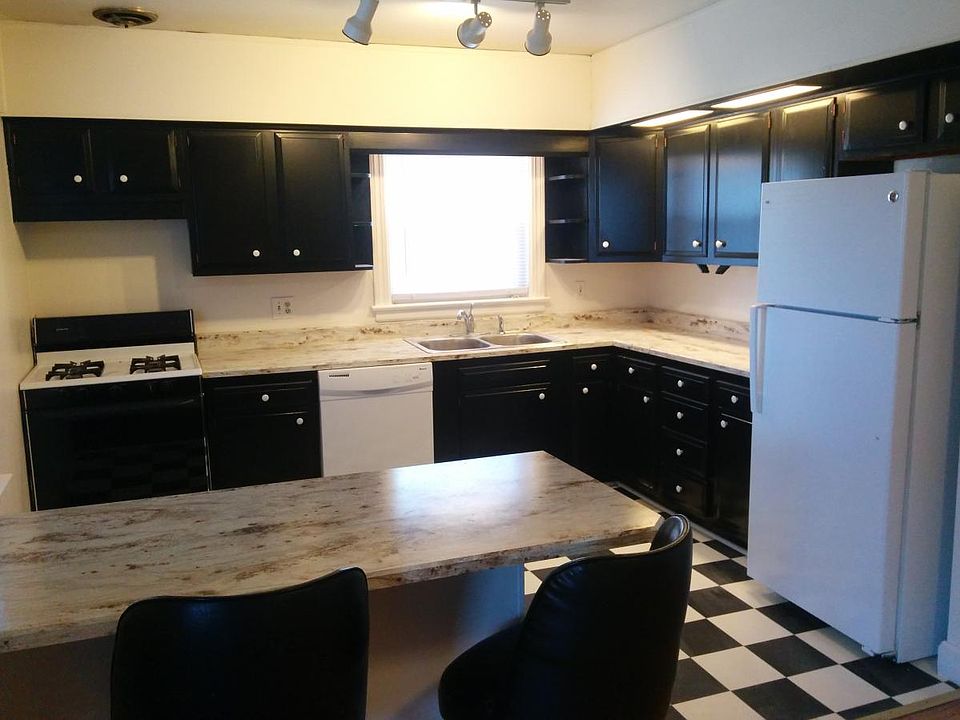 Large bright kitchen with lots of cabinets. New faucet, sink and lighting has been added.