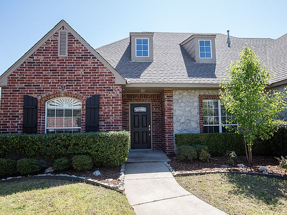 Fabulous curb appeal with stone accents and well-maintained professional landscaping.