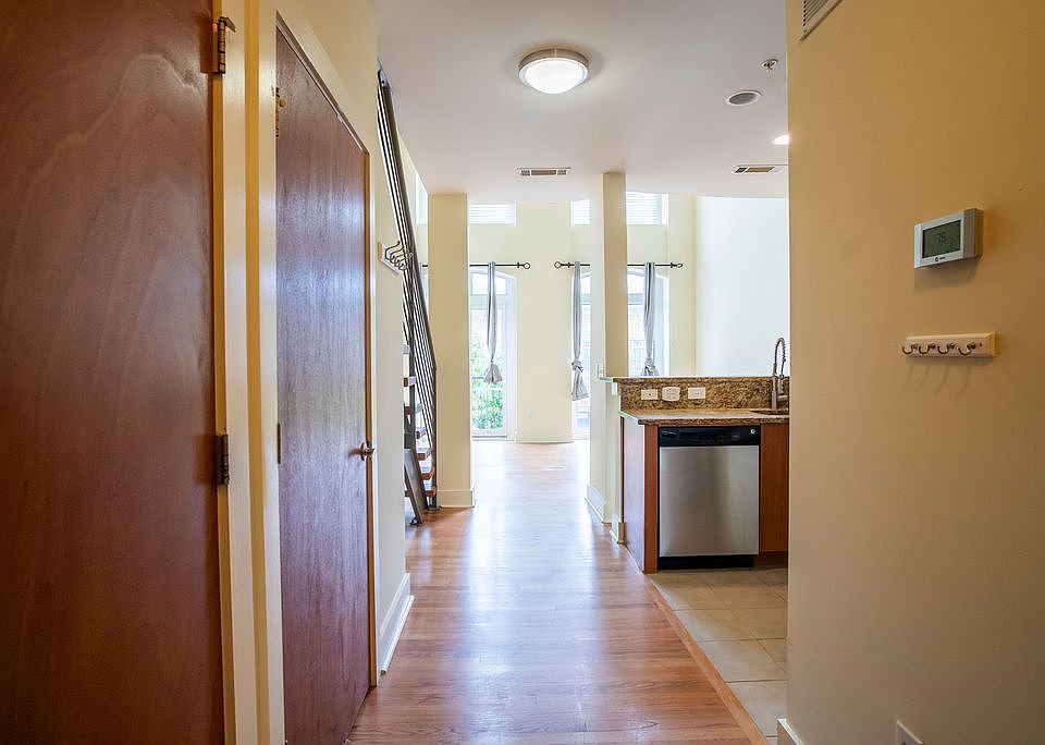 Entryway with laundry and closet to th left. Half bathroom to the right