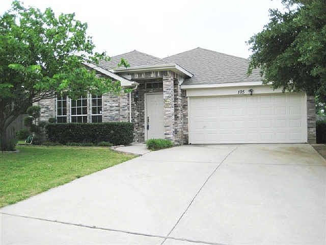 Lush trees and beautiful landscaping greet you at the front drive.