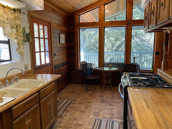 View from kitchen toward oaks off deck.