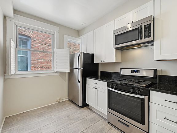 Kitchen area with new stainless steel appliances.