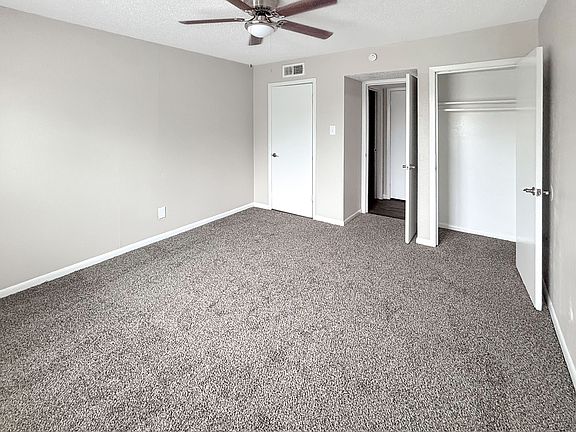 Spacious bedrooms include ceiling fans and ample closet storage at Christy Estates Apartments.
