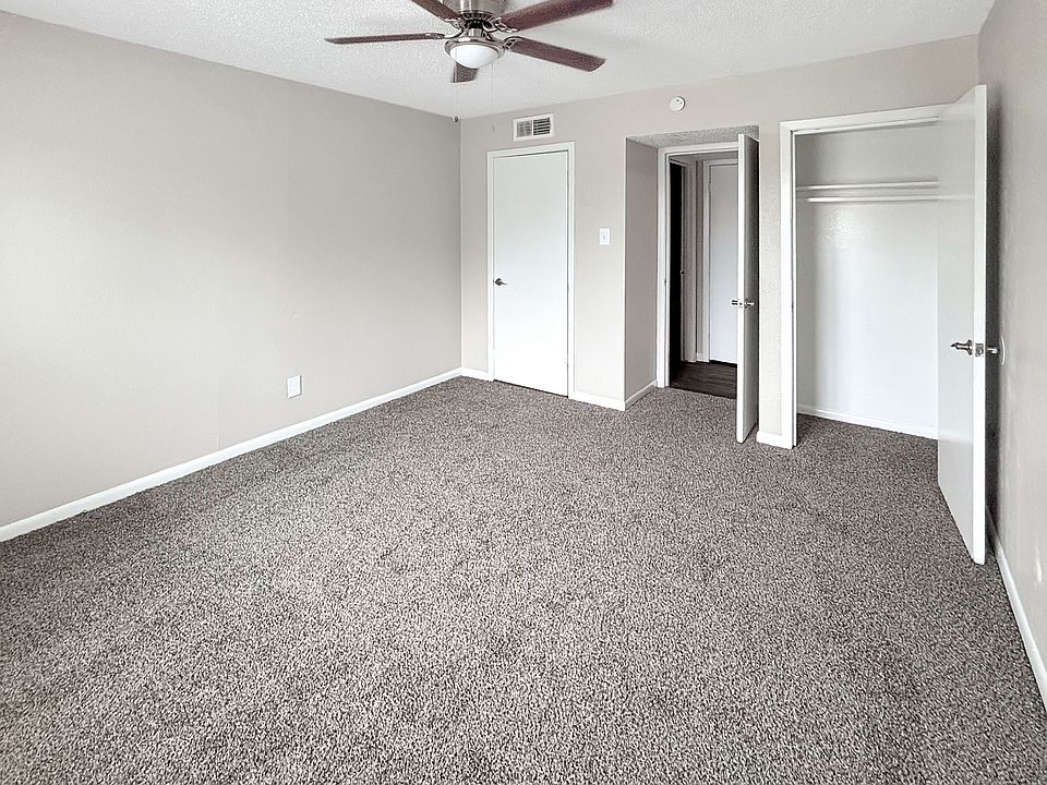 Spacious bedrooms include ceiling fans and ample closet storage at Christy Estates Apartments.