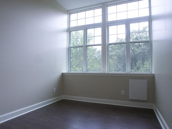 Bedroom with ceiling fan, south facing windows, and (wood blinds not shown and are installed)