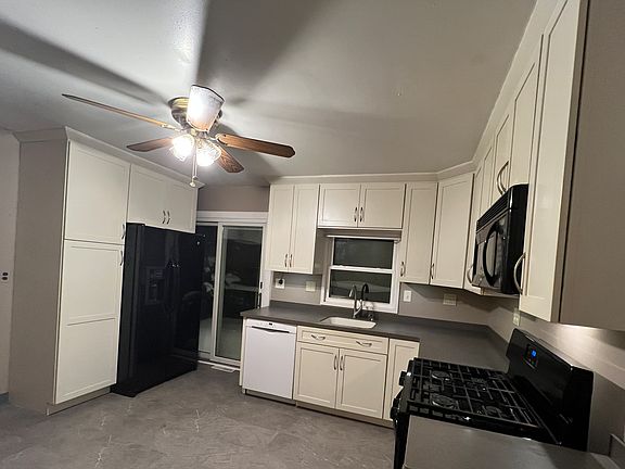 Well-designed kitchen with lots of storage, gas stove, and easy-to-clean counters; appliances included