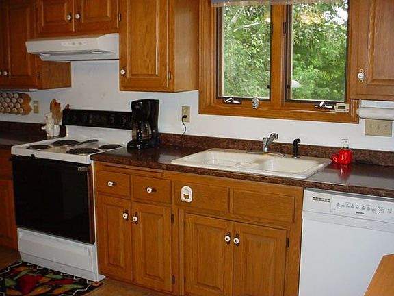Kitchen has new counter and ceramic floor, raised panel oak cabinets
