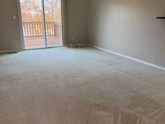 First floor living room with access to rear deck