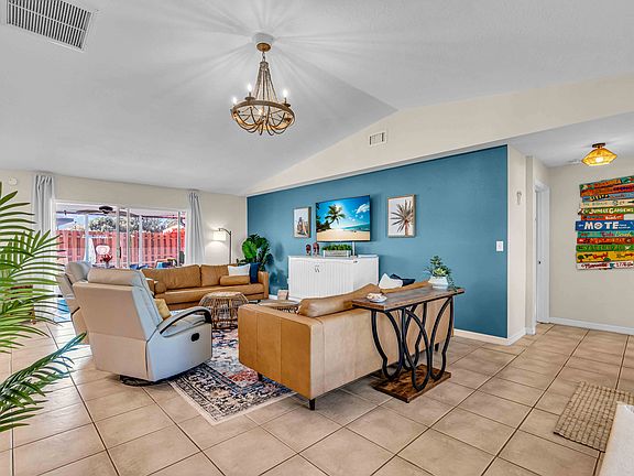 Vaulted ceilings in the living room are the heart of the home connecting the kitchen, living , lanai.