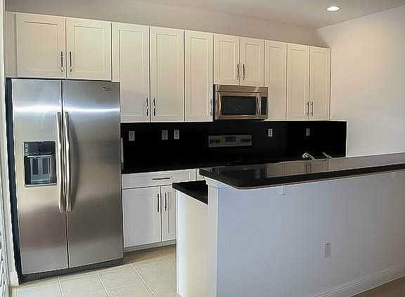 Upgraded "absolute black" granite countertops & backsplash.
