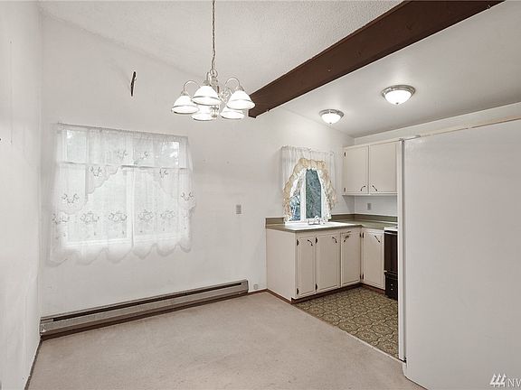 Dining area. Using one's imagination the window would be a perfect opening for French doors to a deck. Or maybe extend the kitchen counters under the windows. 