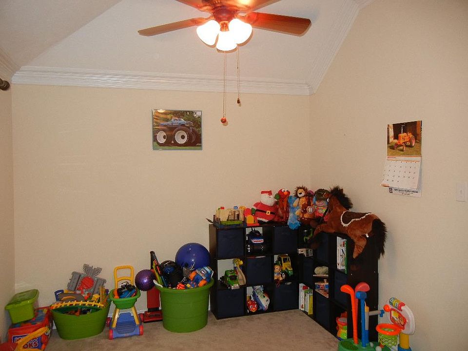 The formal dining  is being used as a playroom.Laminate wood floors under carpet.