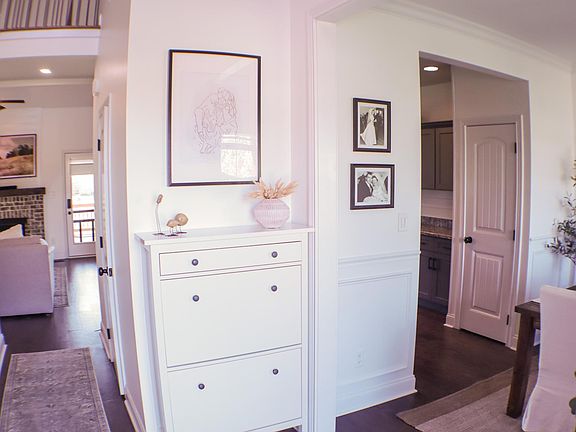Front entry way. Leads to kitchen and formal dining on the right, living room straight ahead, and stairs to the left.