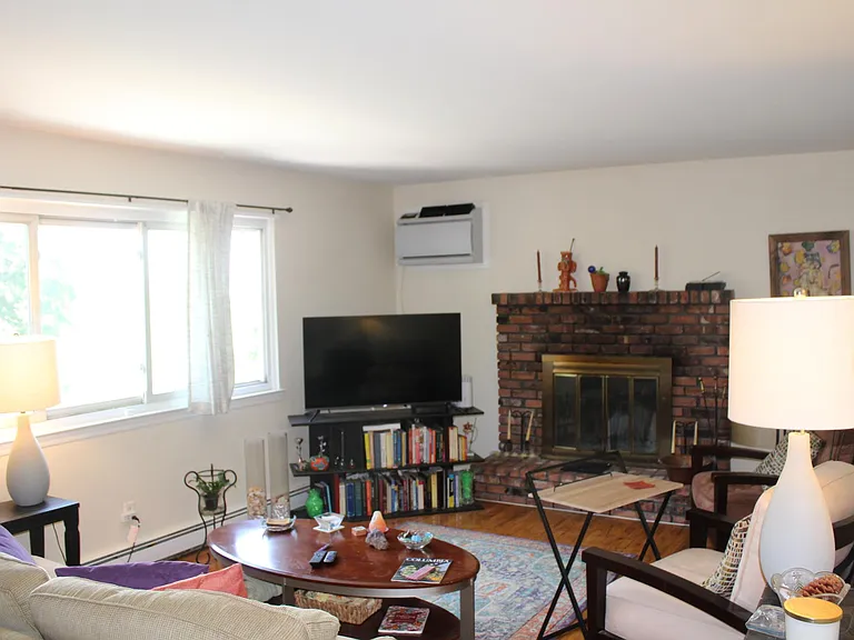 Large Living Room with Fireplace and Seasonal River Views