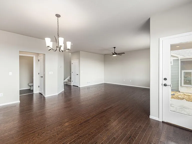 Dining Area with 1/2 bath in the back left and Living Room & Basement/Upstairs entrance