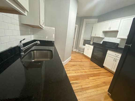 Beautiful black granite on custom counters with white subway tile backsplash throughout kitchen
