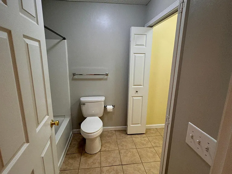 Master Bathroom with full Tub/shower and washer dryer area with closing bifold doors
