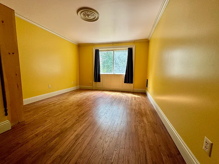 Lower level bedroom with hardwood floor
