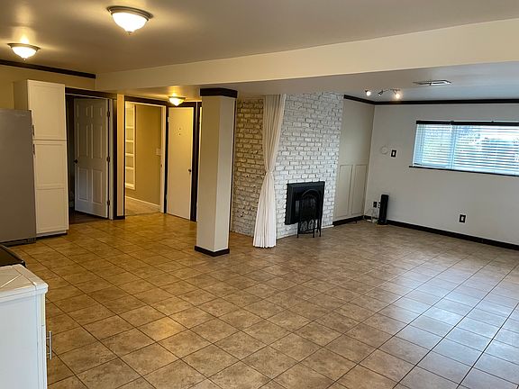 Backyard Patio Door: main living room, kitchen (to the left), laundry room entrance, and hallway to bedrooms.