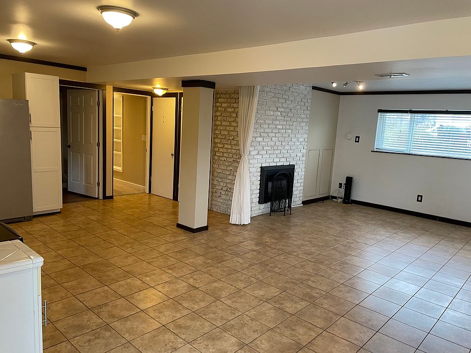 Backyard Patio Door: main living room, kitchen (to the left), laundry room entrance, and hallway to bedrooms.