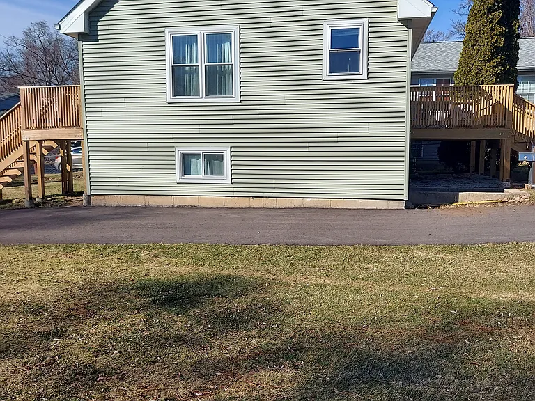 South side of house - showing both front porch and rear deck