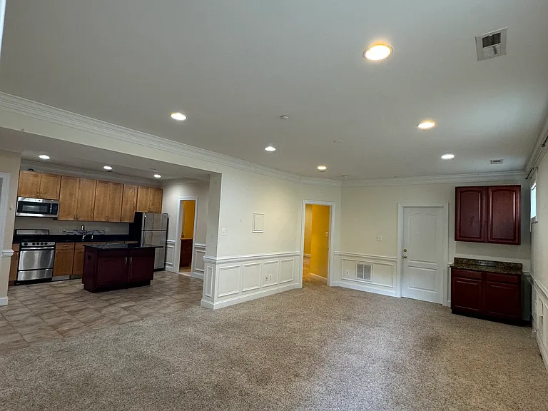 View of kitchen, living area and wine closet from front door.