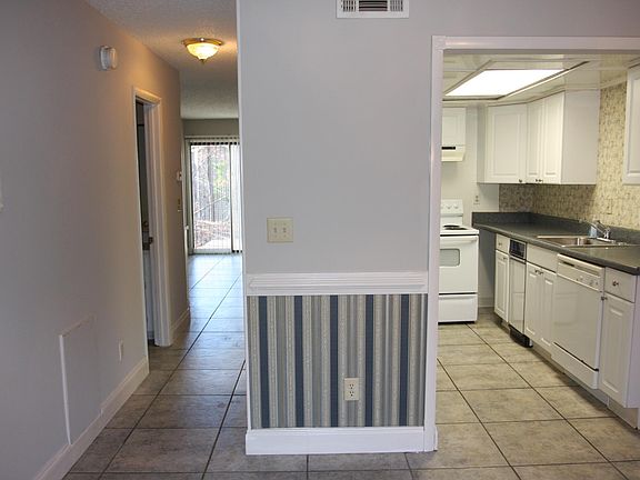 View through dining room to kitchen and hallway to living ro