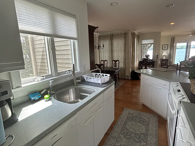 Efficient galley kitchen with electric induction cooktop, microwave, dishwasher, French-door refrigerator. Fully stocked with cookware, plates, glassware, flatware, coffee maker, cooking utensils, baking pans and more.
