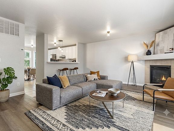Family room with gas burning fireplace. (Furnishings for illustrative purposes only, not included.)