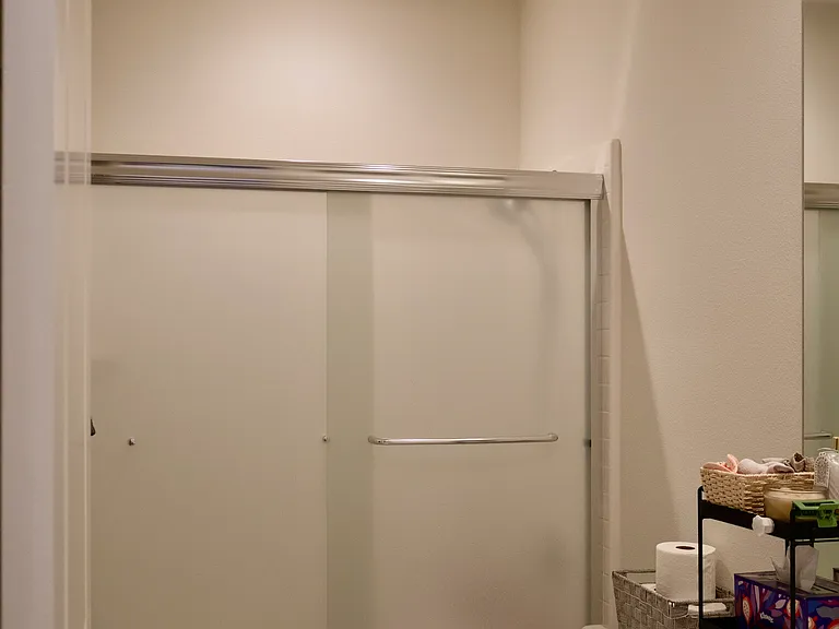 Bathroom 2: Features a single sink, toilet, and shower-tub combo layout.