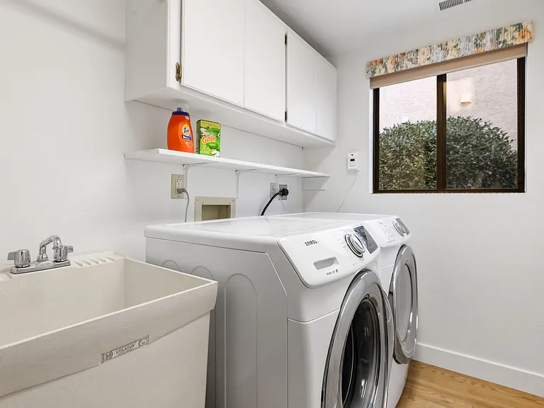 A fully equipped laundry room located downstairs