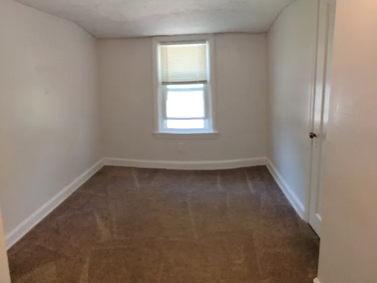 2nd floor bedroom #2 with window, closet and door to 1/2 bath.