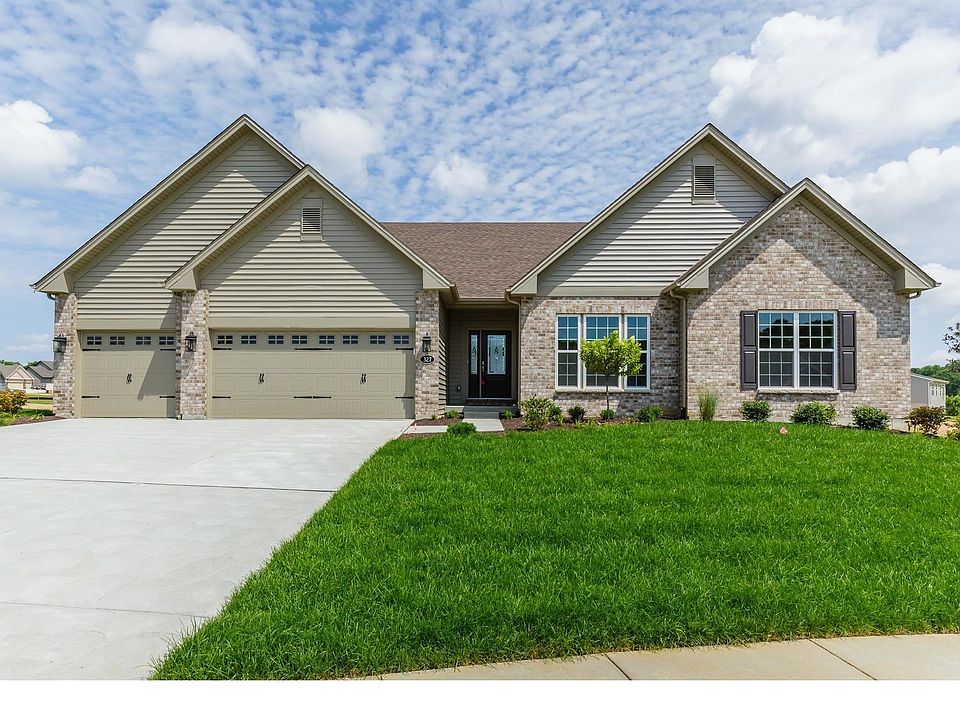 Front Elevation with 3 Car Garage and Brick Facade