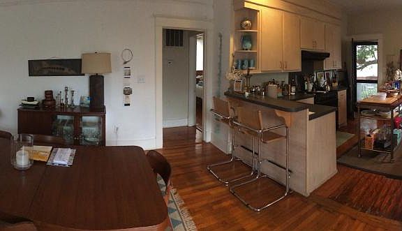 Panorama of open kitchen dining living combo