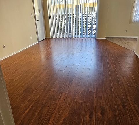 Large light and airy living room, laminate floors, vertical blinds