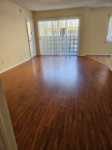 Large light and airy living room, laminate floors, vertical blinds