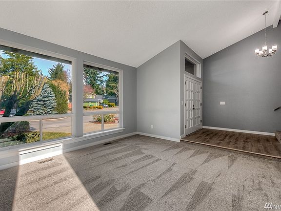 Oversized windows allow the light to stream in...enjoy all new flooring