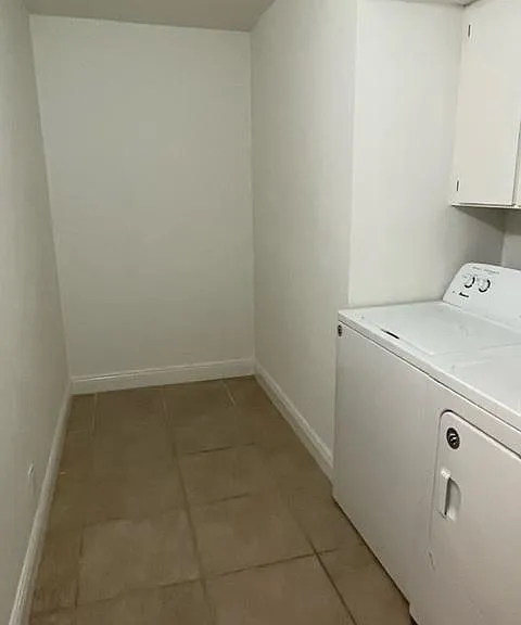 Laundry room with storage area.