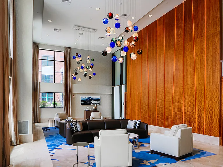 Soaring ceiling and unique light design featured in this residents lounge