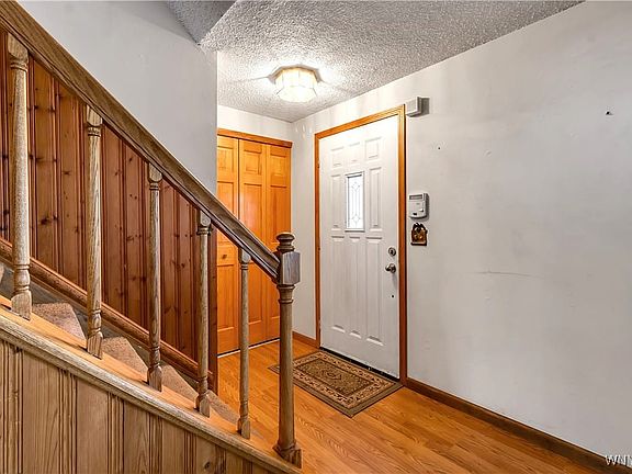 Front door entry with guest closet + laminate floo