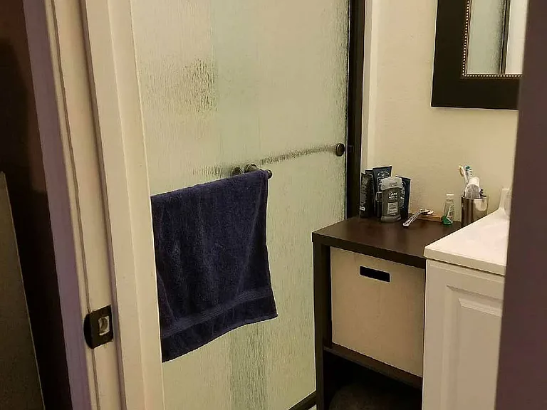 Rain effect glass sliding shower doors in the standing shower.