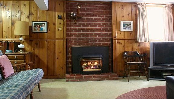 Beautiful solid wood paneling, floor to ceiling bookcases and gas fireplace
