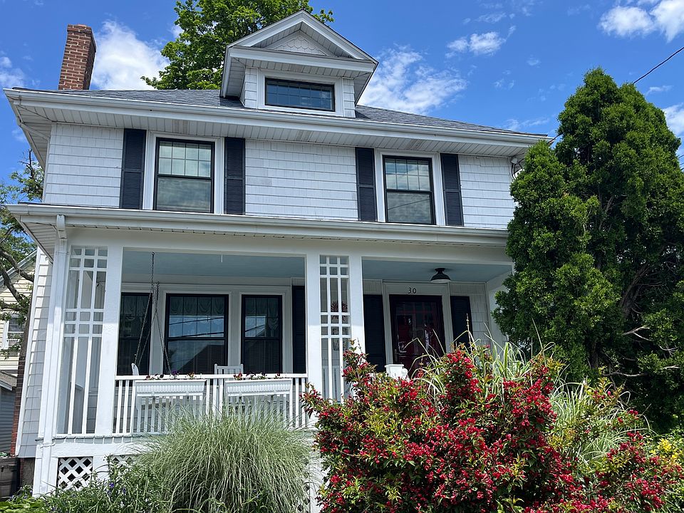 Front view of house. Porch includes rockers and swing.