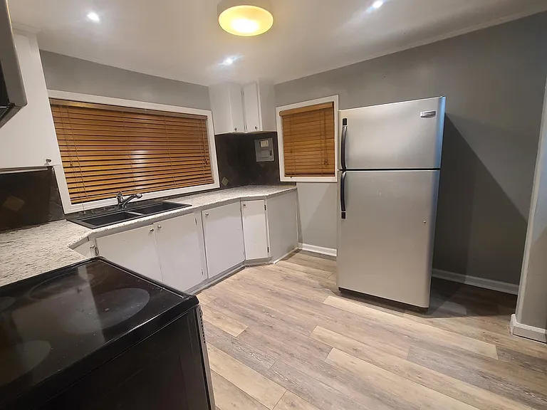 Large kitchen has new granite and flooring.