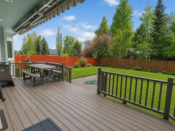 Large covered deck area with tables, BBQ, and extendable coverage