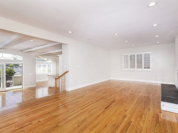 There are three fireplaces. The living room is separate from the other rooms and there are hardwood floors throughout most of the house.