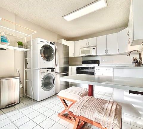 Kitchen includes: washer, dryer, refrigerator, lots of shelving, gas range, microwave, touchless faucet, filtered water, and seating