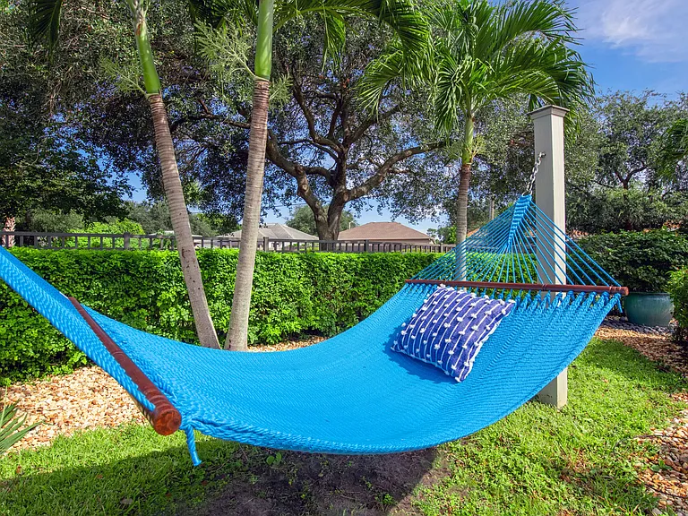 Drift away in a blissful hammock cocoon, nestled under swaying palms and kissed by the warm Florida sun.